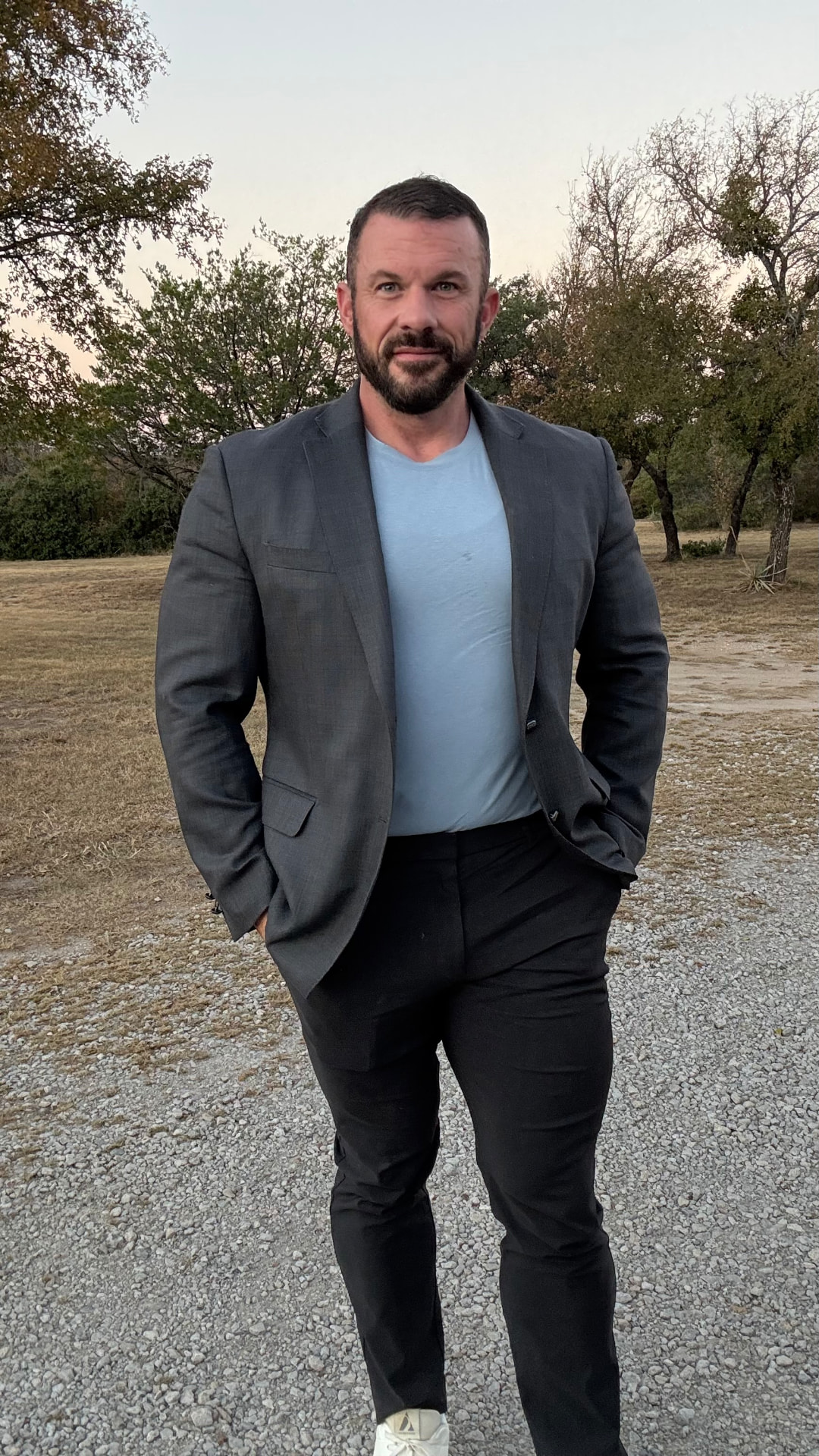 Chad Vermillion in a blazer over a t-shirt, outdoors at golden hour